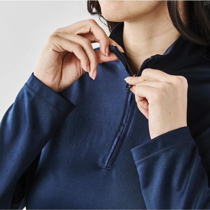 A women's navy blue Monterey 1/4 zip pullover, featuring a zip collar and long sleeves. It has a logo restraint.