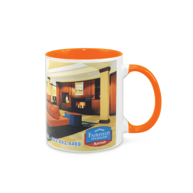 A two-tone coffee mug featuring an orange interior and handle, with a white exterior showcasing an image and logo.
