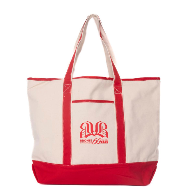 A cream canvas tote bag with red handles and a logo on the front.