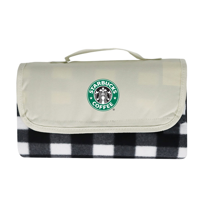 A picnic blanket featuring a black and white checkered pattern with a light grey cover and a logo.
