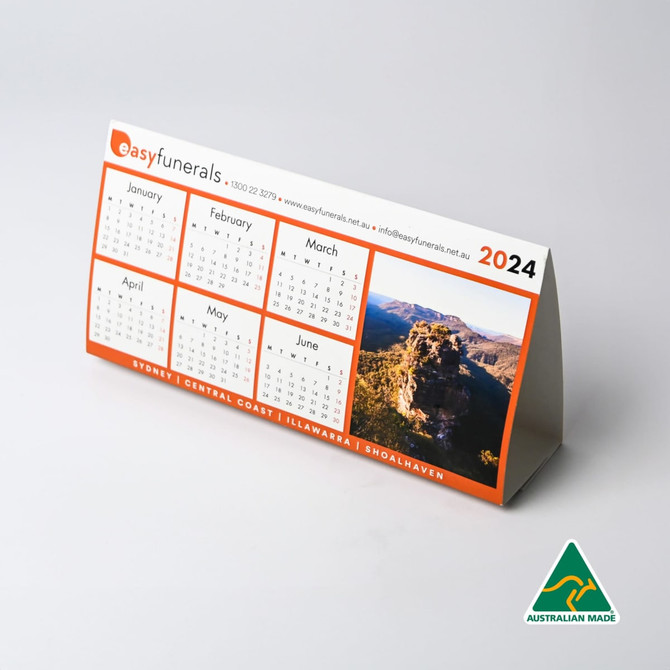 A desk calendar for 2024 with a scenic image, featuring an orange and white design, and a logo.