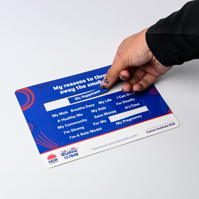 A hand interacts with a colourful card featuring reasons for quitting smoking, with various motivational phrases displayed.
