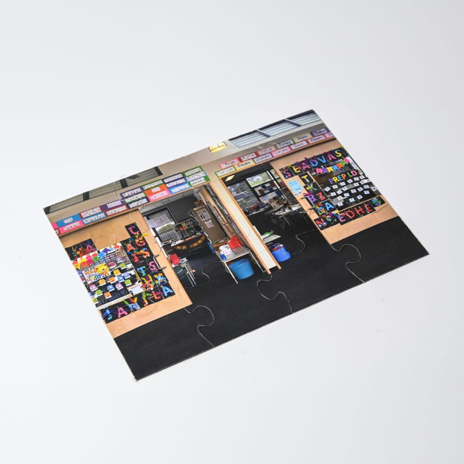 A5 Magnetic Jigsaw with colourful puzzle pieces featuring a classroom scene and educational displays.