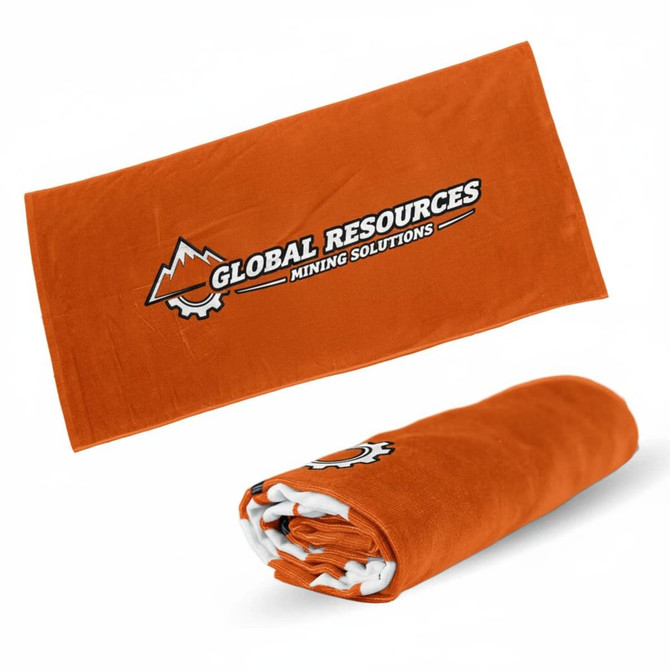 An orange beach towel rolled up, featuring a logo, and measuring 70cm x 140cm.