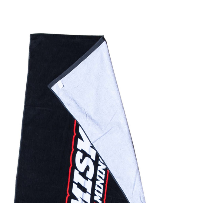 A black and grey beach towel featuring a soft cotton material and a logo on one side.