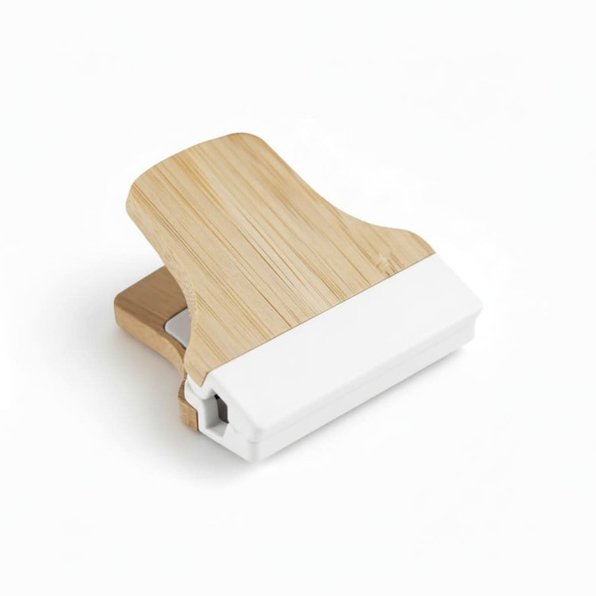 A bamboo fridge magnet clip with a natural wood finish and a white base, designed for holding notes or papers.