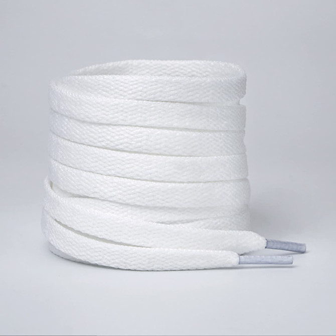 A set of white shoelaces with grey tips, neatly coiled together. The shoelaces have a textured appearance.