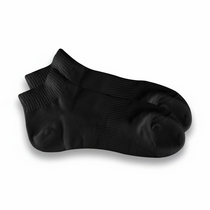 A pair of black ankle grip socks with textured detailing and a logo on one sock.