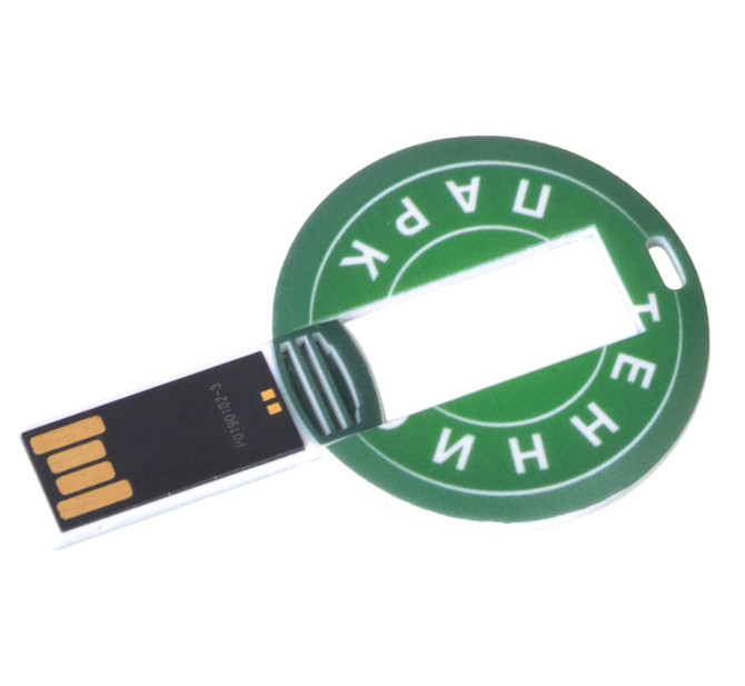 A round, green flash drive with a circular design and a USB connector extending from one side. It features a branding logo.