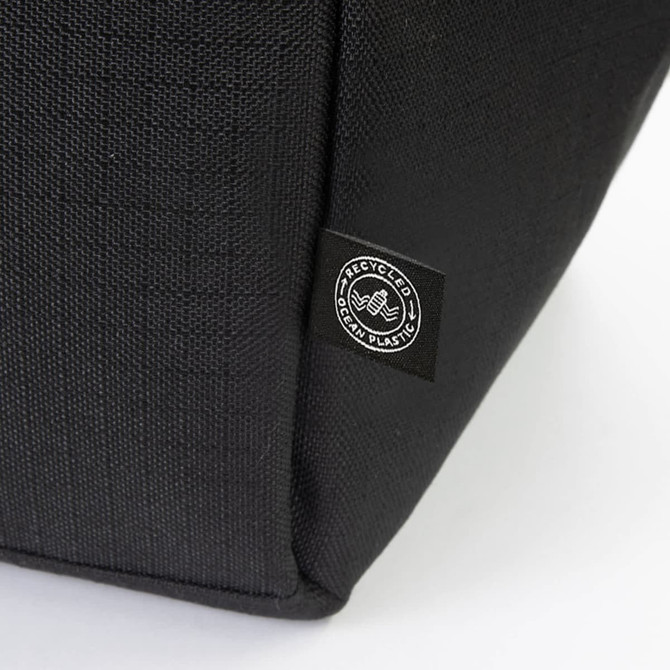 A black cooler bag featuring a logo, made from recycled materials. The textured fabric is visible in the image.