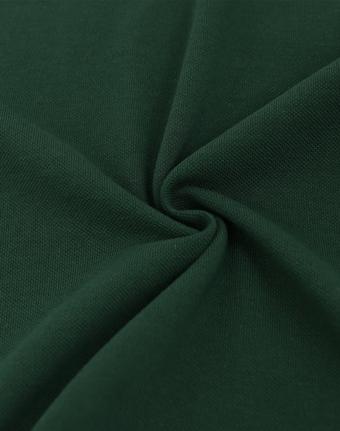 A close-up of dark green fabric with a smooth, textured finish, showcasing its soft cotton/poly blend.