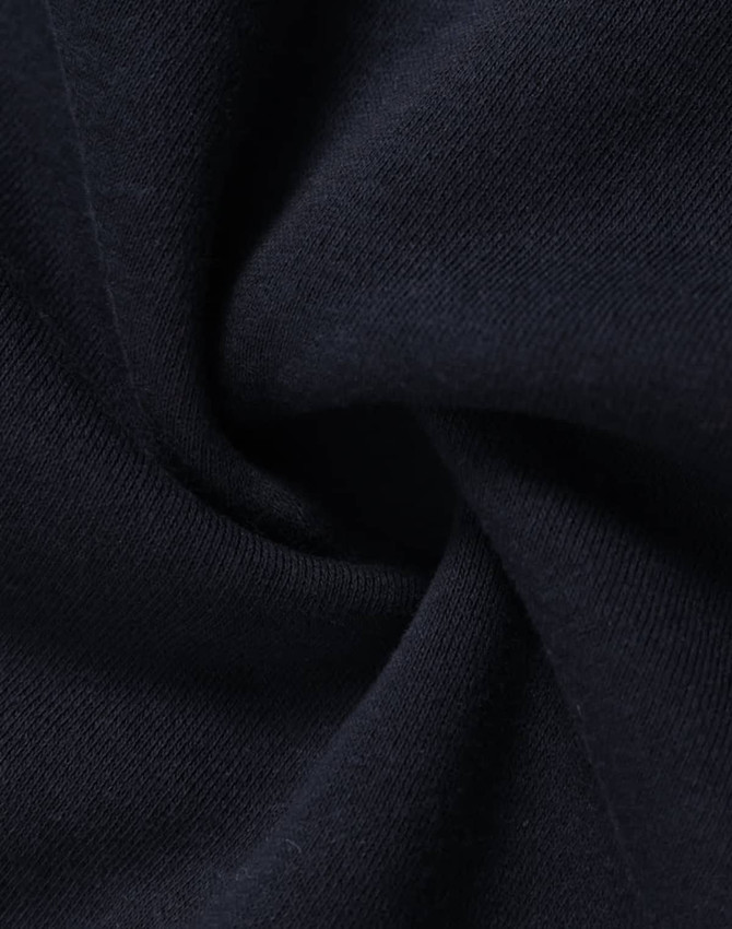 A close-up of navy fleece fabric showcasing its soft texture and smooth finish. The fabric has a subtle sheen.