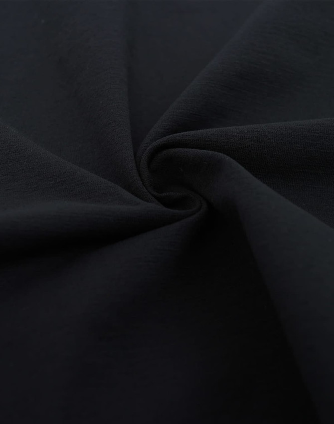 A close-up of black fabric in a swirling pattern, showcasing a soft texture ideal for apparel.