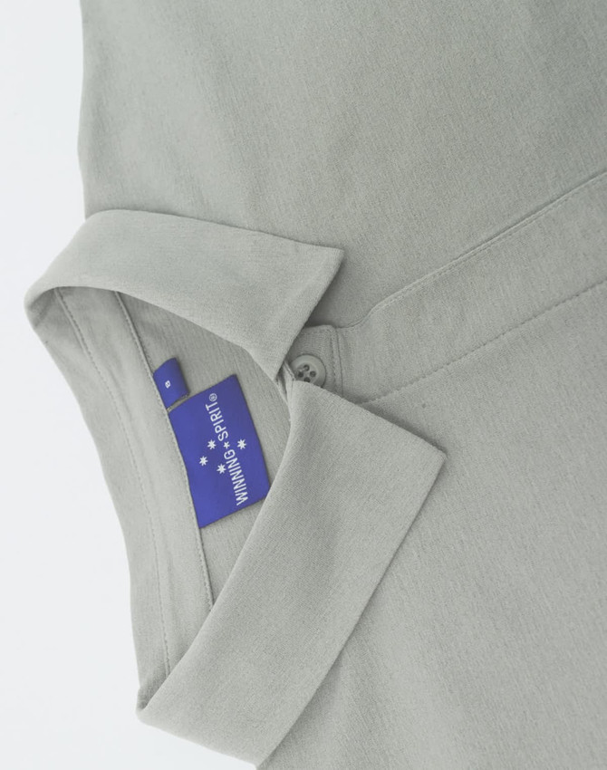 A grey ladies' high performance graphene polo with a collared neckline and a hidden button placket, featuring a logo.