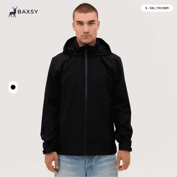 A man wearing a black Core Weather Jacket, featuring a hood and front zip, stands against a neutral background.