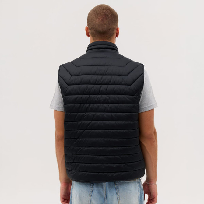 A black puffer vest with a quilted design, viewed from the back, worn by a person.