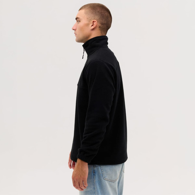 A side view of a black fleece 1/4 zip jumper, featuring a high collar and a relaxed fit. It has a logo on the chest.
