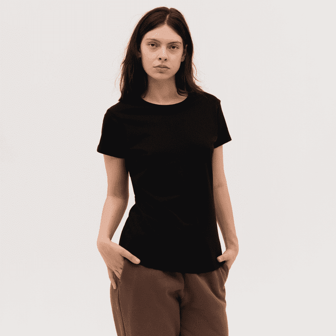 A black women's tee with a round neckline and short sleeves, modelled by a woman with long hair.
