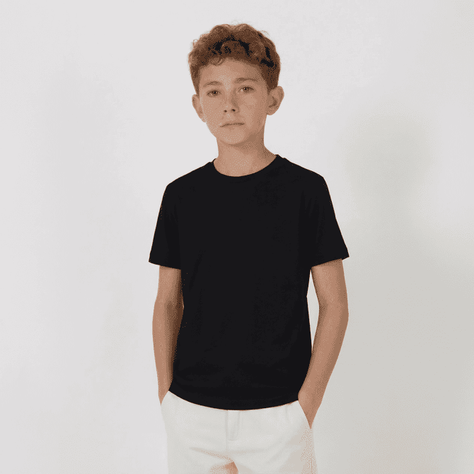 A black youth tee displayed on a child, standing with hands in pockets against a plain background.