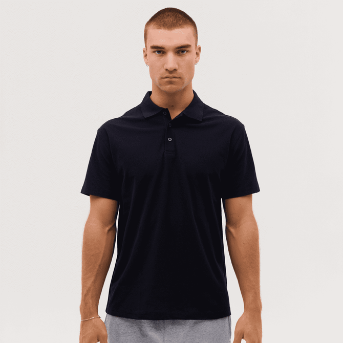 A black polo shirt with a collar and three buttons, featuring a logo on the chest.