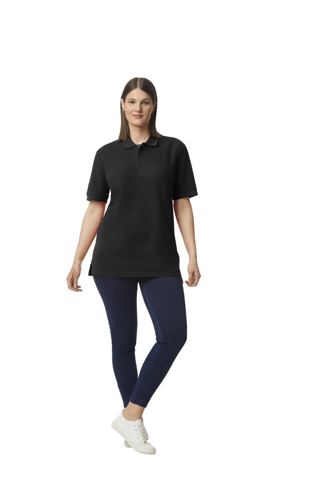 A black Gildan Hammer Adult Double Pique Polo, styled with a woman wearing navy trousers and sneakers.