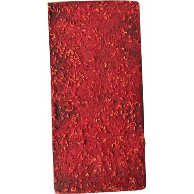 A block of chocolate-covered dried raspberries, featuring a vibrant red colour and textured surface.