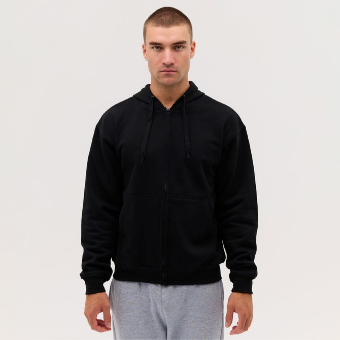 A black zip hoodie displayed on a model wearing grey sweatpants, featuring a hood and front pockets.