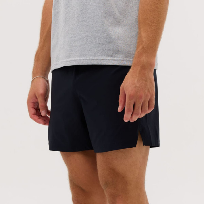 Navy running shorts with side slits, worn by a person in a grey t-shirt. The shorts have a minimalist design.