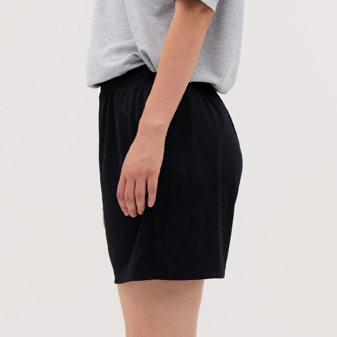 A pair of black shorts with an elastic waistband, displayed on the side with a neutral background.