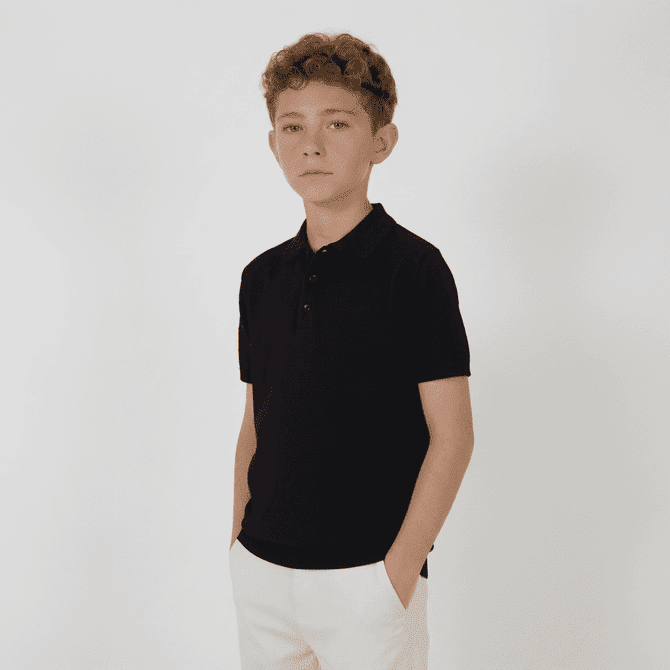 A youth's black polo shirt with a collar and buttons, featuring short sleeves. It has a logo on it.