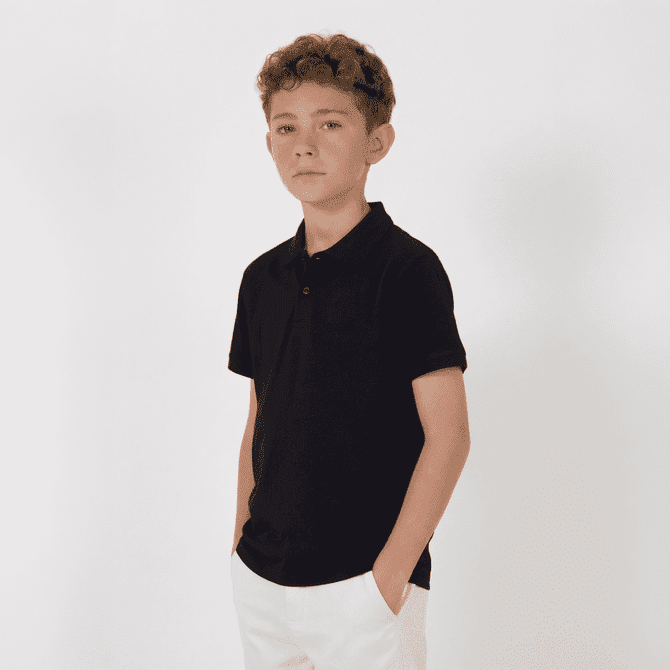 A black youth polo shirt displayed on a young model against a white background.