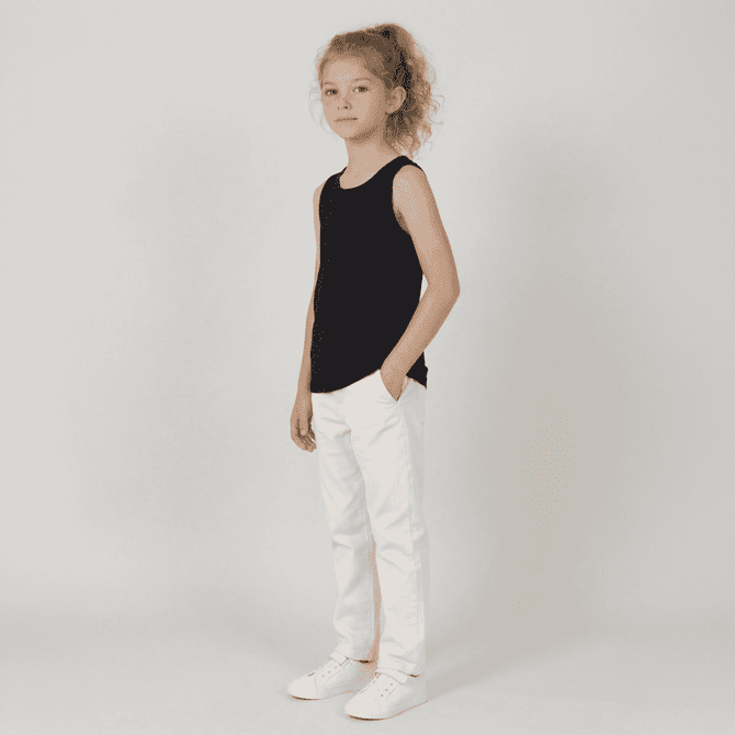 A youth singlet in black, styled with white pants and white shoes, featuring a logo.