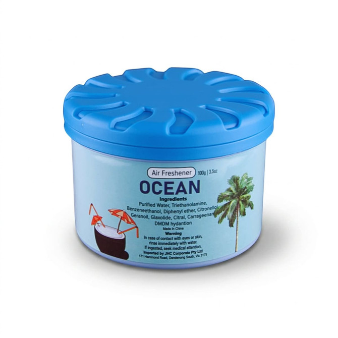 A blue air freshener container with a lid, labelled "Ocean," featuring tropical drink illustrations.
