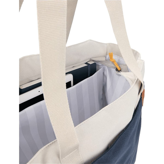 A navy and cream tote bag with a striped interior, featuring straps and an interior pocket for storage.