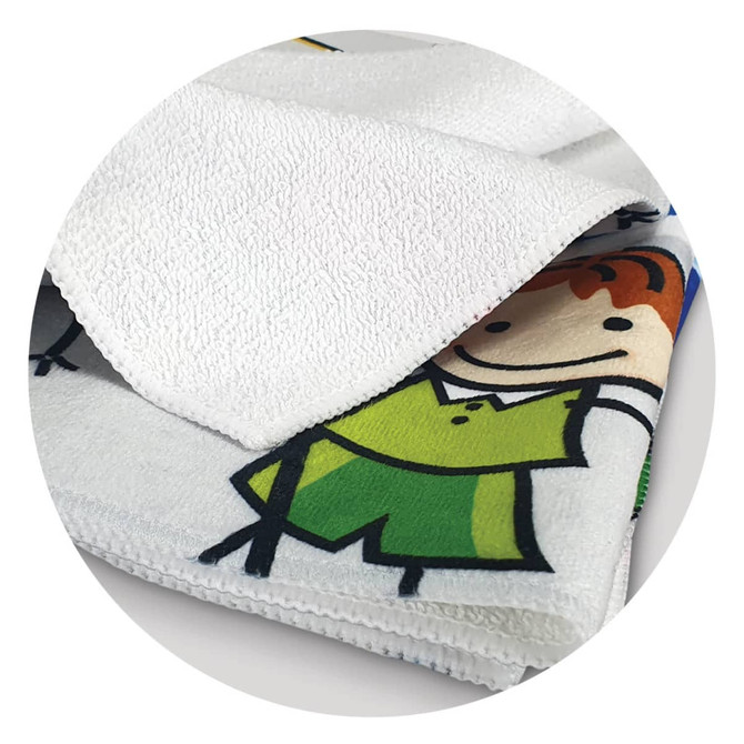 A vibrant, full-colour tea towel featuring playful cartoon designs, predominantly in white, green, and yellow shades.