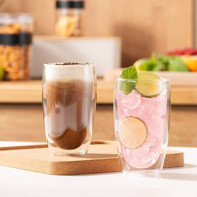A set of two large double wall glass tumblers, featuring a coffee drink and a pink beverage with lime slices.