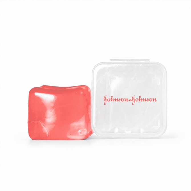 A red jelly cube sensory toy beside a transparent plastic case with a logo.
