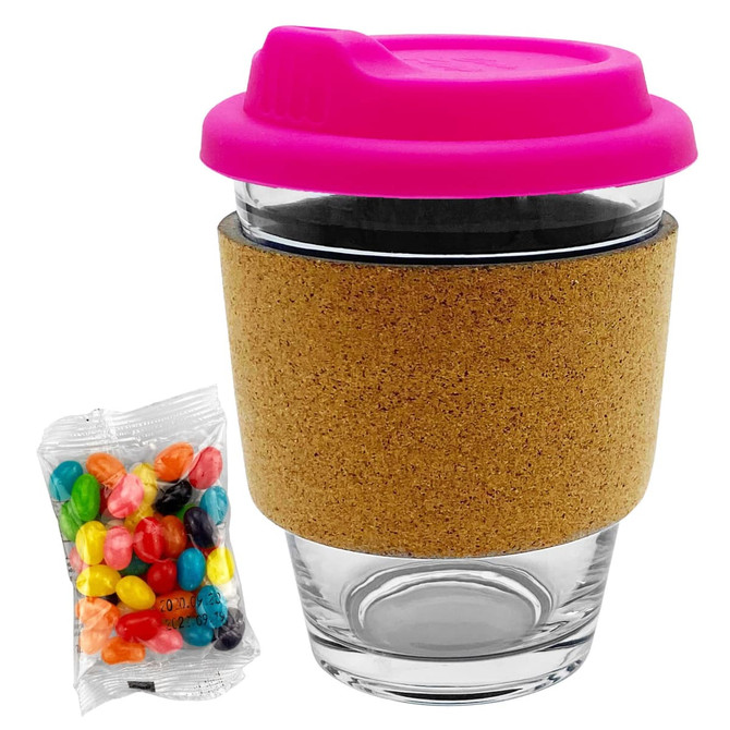 A glass coffee cup with a pink lid and cork band, accompanied by a packet of colourful jelly beans.