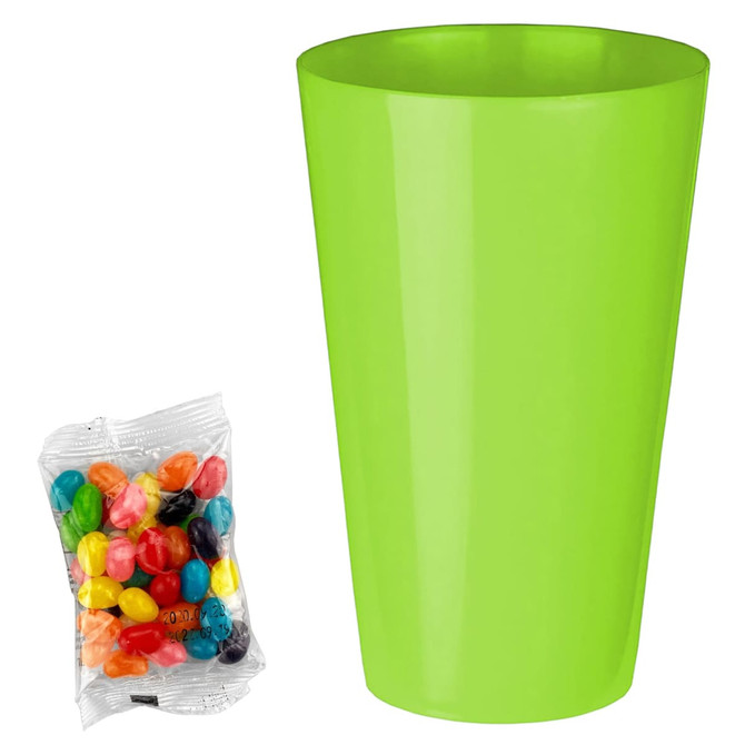 A bright green cup next to a packet of assorted jelly beans in various colours.