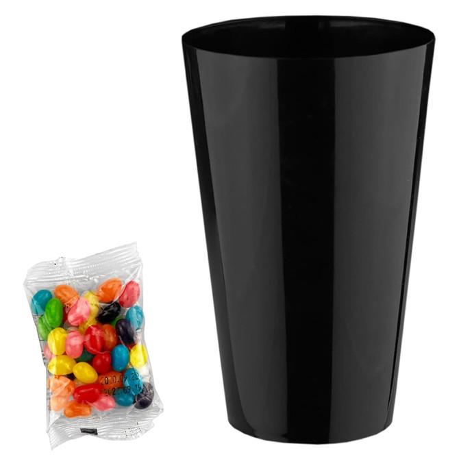 A black cup alongside a packet of colourful jelly beans in assorted hues. The cup is tall and cylindrical.