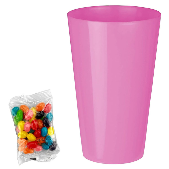 A pink party cup next to a clear bag of colourful jelly beans in assorted flavours.
