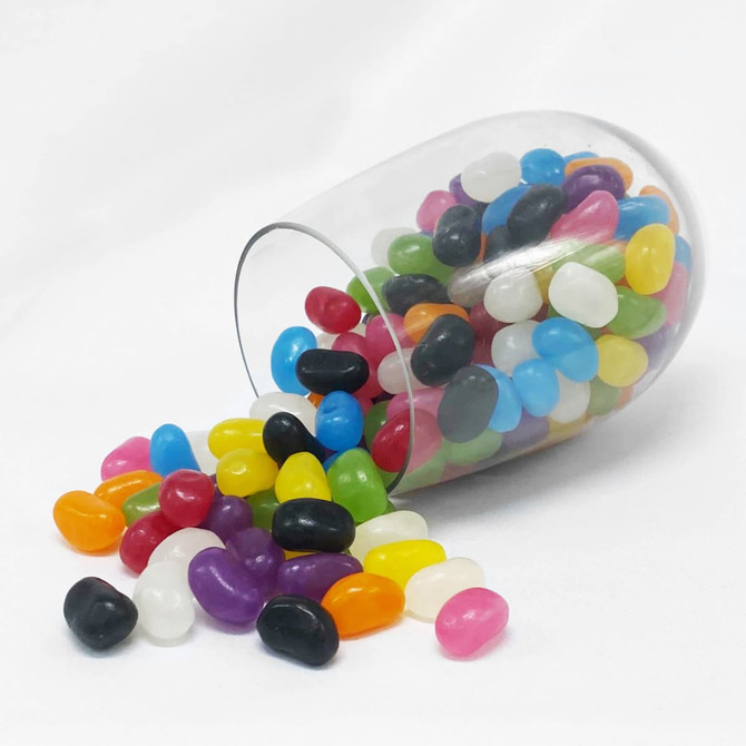 A clear crystal PET cup with an assortment of vibrant jelly beans in various colours, some spilling out.