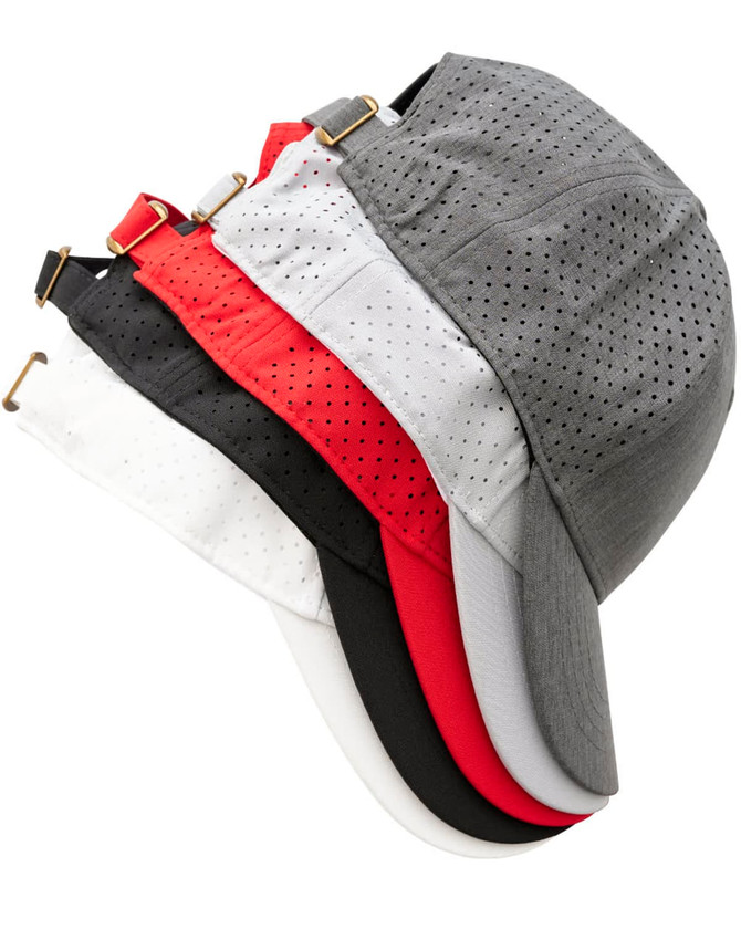 A collection of 4-way stretch laser cut runner's caps in grey, black, white, and red, featuring a logo.