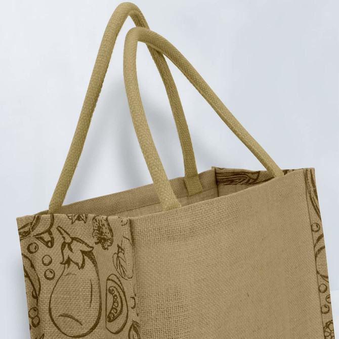 A jute tote bag in a natural beige colour with twin handles and a patterned side design. It's unbranded.