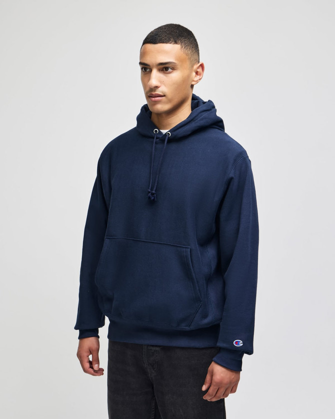 A navy hooded sweatshirt with a front pocket and a logo on the sleeve.