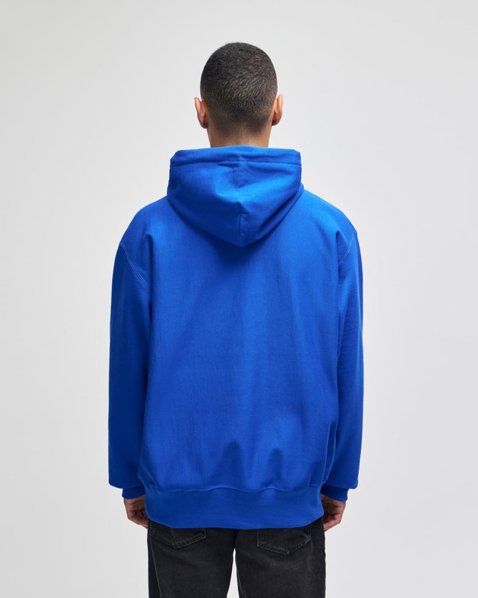 A blue pullover hooded sweatshirt with a large hood, viewed from the back. It features a logo.