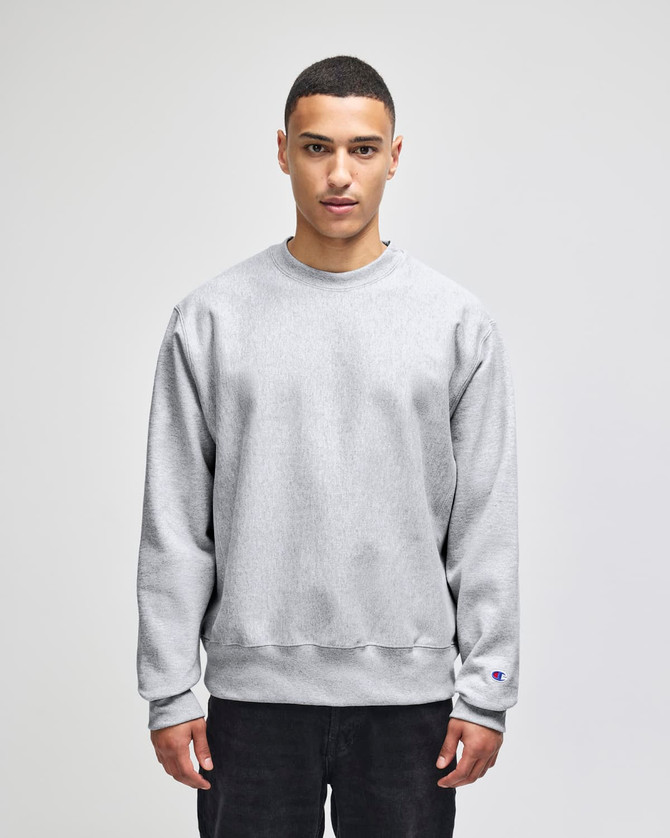 A grey Champion Reverse Weave® adult crew sweatshirt with long sleeves and a relaxed fit, featuring a logo.