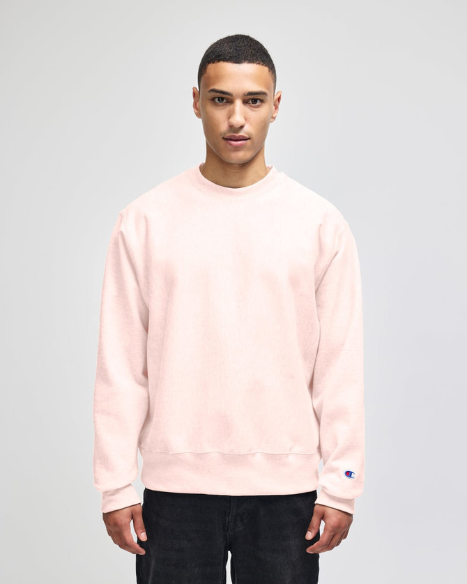 A beige Champion Reverse Weave® adult crew sweatshirt with a relaxed fit and a logo on the sleeve.