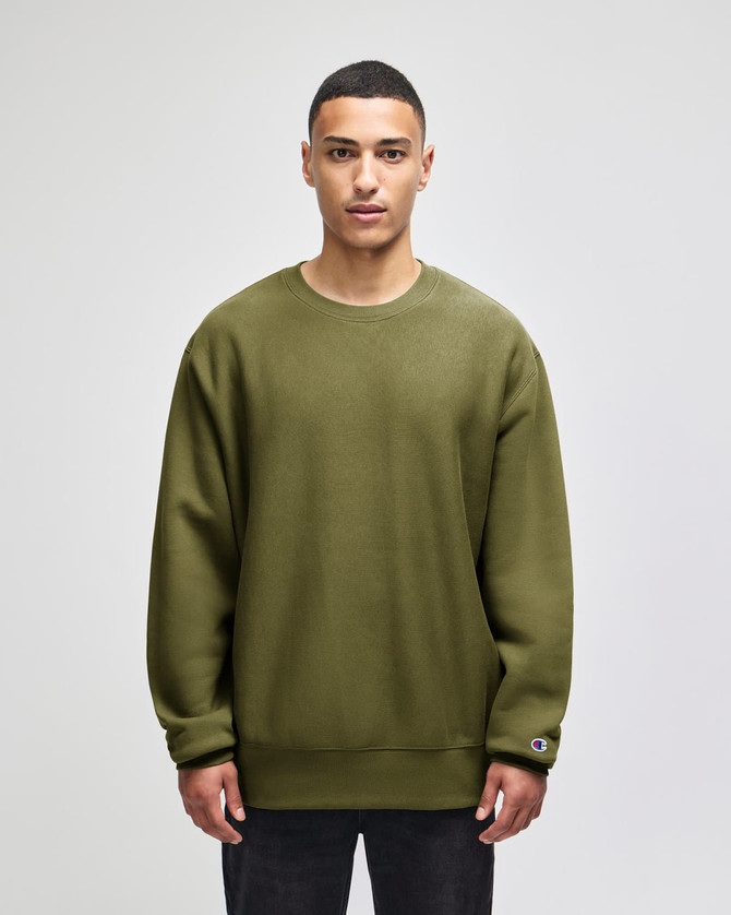 An olive green crew sweatshirt with a relaxed fit and a small logo on the sleeve.