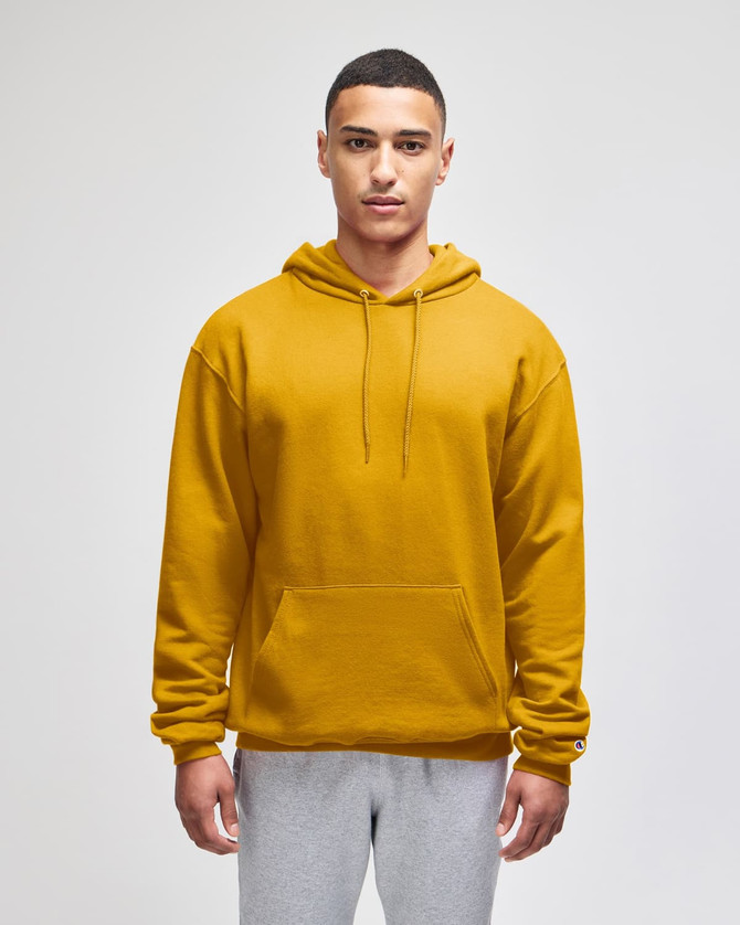 A mustard yellow pullover hooded sweatshirt with a front pocket and a logo on the sleeve.